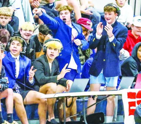 THE NEXT GENERATION? Members of the Kingfisher High School student section had their own makeshift broadcast table as part of their theme during last Tuesday’s home basketball games against Alva. The “broadcast crew” consisted of, from left, Luciano