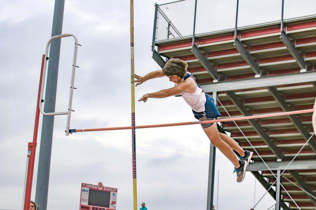 KHS SENIOR Kase Simon clears the bar during the pole vault at the Class 4A regional meet. Simon placed fifth and his new personal record of 9 feet proved enough to qualify him for this weekend’s state meet. [Photo by Chris Simon/www.simon-sports-photos. Simon soars to new heights