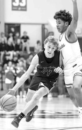 SENIOR GUARD Croston Martin (24) drives against Dale during last Friday’s semifinal game. Martin and the Jackets won two of three games in the tournament for third place. [Photo by Russell Stitt/www.stitt.smugmug.com]