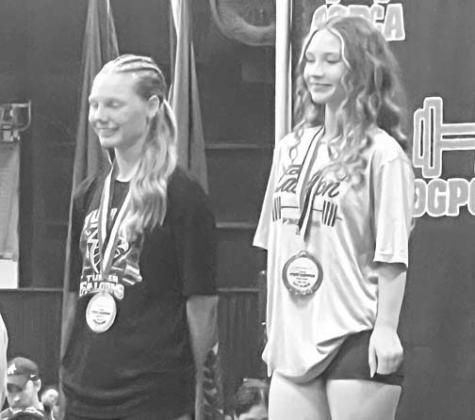 MAKAYLA HINES (right) stands atop the podium after winning the OGPCA 105-pound title. [Photo provided]