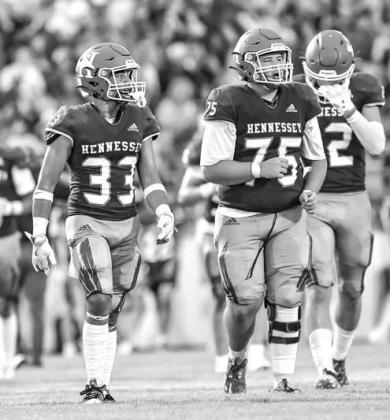 HENNESSEY’S Jakob Johns (33) and Titan Root (75) combined for 13 tackles Thursday night. [Photo by Chris Simon/ www.simon-sports-photos.smugmug.com]