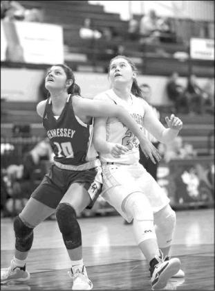 HENNESSEY’S Meagan Tillman (10) and Cashion’s Issy Reeves (24) battle for position in the lane during their teams’ quarterfinal game on Thursday.             [Photo by Russell                           Stitt/www.stitt.smugmug              