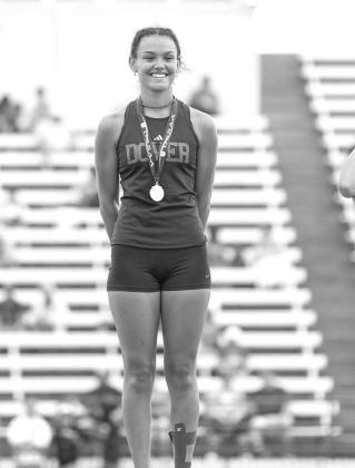 DOVER’S KYLEE BELL on the medal stand after winning the pole vault at the Class A state track and field meet last Friday. [Photo by Rylee Broadbent]