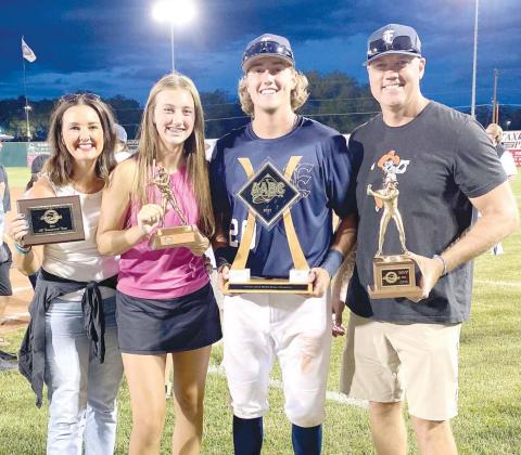 TROPHY COLLECTION – Ian Daugherty didn’t have enough arms to hold all the hardware he won at the 2021 Connie Mack World Series, but he did have enough family to help him out. Daugherty is holding the team championship trophy. From left, his mother, Mi ‘Best I’ve Ever Been Around’