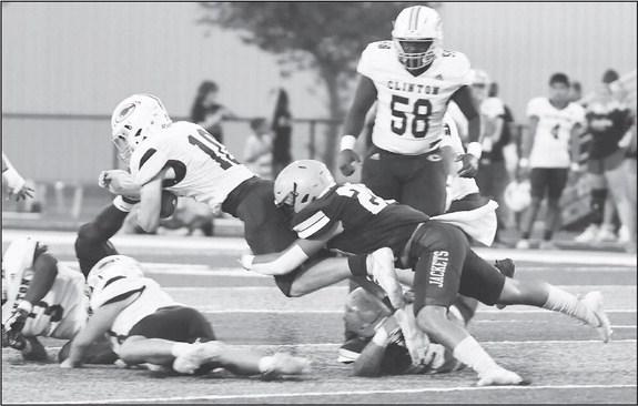 KHS LINEBACKER Jairo Velarde brings down Clinton quarterback Cooper Sulley during last Friday night’s game. The teams were scoreless in the first half before the Reds pulled out a 20-0 victory with a strong second half. [Photo by KHS Photography/www.khs Jackets blanked by Red Tornadoes