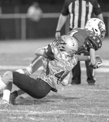 SLADE SNODGRASS (4) pulls down a Chisholm offensive player during Kingfisher’s victory last week. Snodgrass led the team with nine tackles. [Photo by Russell Stitt/www.stitt. smugmug.com]