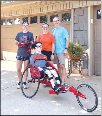 THE SMILES SAY IT ALL – Hunter Wittrock, center in his new adaptive jogger, is preparing to race in the Little Red Heart 5k in Oklahoma City on Saturday, Sept. 23. Bethany Piotrowski, far left, will be the primary force propelling Hunter to the finish l Team Hunter Ready to Roll