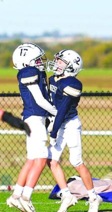 TOUCHDOWN JACKETS! – Kingfisher’s Bryson Black, left, and Cooper Myers celebrate after a touchdown Saturday in their team’s 30-8 victory over Crossings Christian in their fifth and sixth grade league championship. For more information, see Page 2A. 