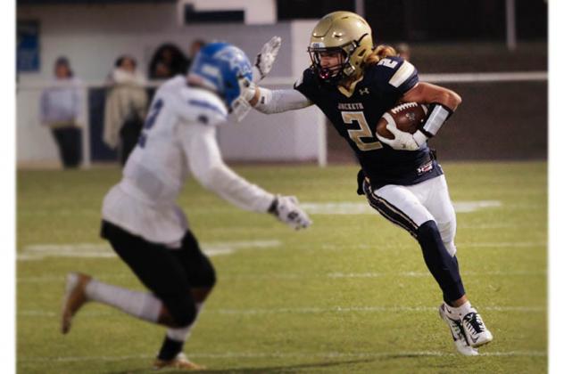 KHS SENIOR Keaton Abercrombie (2) stiff-arms a Bridge Creek defender during the Yellowjackets’55-13 victory over Bridge Creek last Friday. Abercrombie had eight catches for 179 yards and two touchdowns. [Photo by Hayden Wittrock/KHS Photog Article Image Alt Text