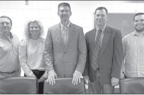 HENNESSEY BOARD OF EDUCATION members elected new officers, and welcomed a new member, during their Monday meeting. Pictured are, from left: Luke Lough, Amy Charmasson (clerk), Dr. James M. Matousek (president), Lance Painter (new board member) and Dakota 