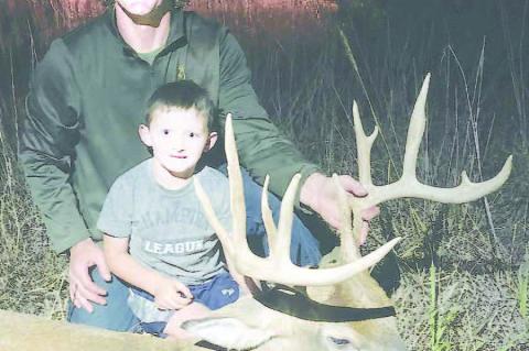 ANOTHER BIG BUCK – Tyrel and Milo McLane with one of the many nice bucks Tyrel locates for friends and family members. [Photo provided]