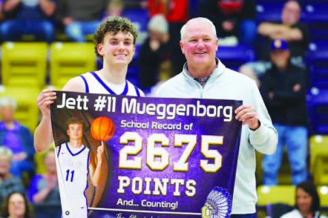 OKARCHE SENIOR guard Jett Mueggenborg gets set to release the shot that gave him the school’s all-time scoring record. Mueggenborg’s was tied with Barry Schwarz at 2,674 points when he nailed the shot pictured left. He went on to score 34 points in th