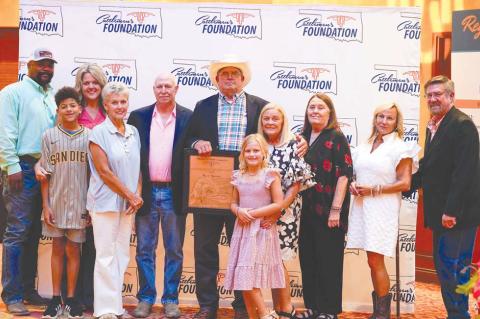 YEOMAN HONORED – Dover’s Byron Yeoman (holding plaque) was named the 2025 Oklahoma Cattleman’s Association Cattleman of the Year recently. He was joined at the award presentation by several family members, including, from left: Tyrone Bell, Kyson Cl