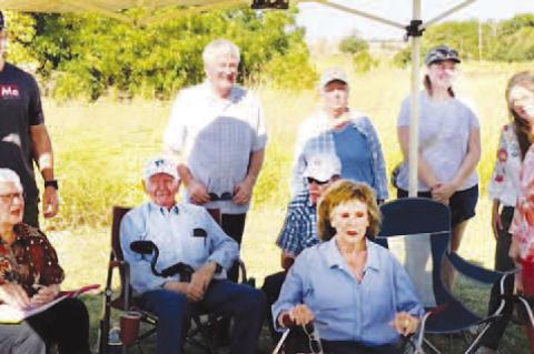 HONORING VIRGIL – After years of research to determine the location of an unmarked grave for the infant son of W.R. and Mable Helt, Virgil Lawrence, born in 1910, Evelyn Helt-George, seated far left, gathered with other family members for a ceremony and the placing of a headstone at Grimes Cemetery. Others present were: seated, right of Helt-George, James Helt, Ed Smith and Wilma Duffy; standing from left, Douglas George, Marty Williams, Sue Smith, Erin Kochenower, Marcie Patterson and Lucinda Grimes-Moore.