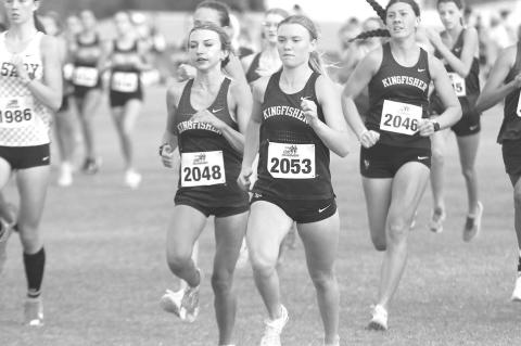 KINGFISHER’S Lily Lunsford (2048), Scout Snodgrass (2053) and Harper Evans (2046) try to make their way to the lead of the pack at the start of Thursday’s cross country race at Heritage Hall. All three runners medaled for KHS as Snodgrass won the individual honor and the team placed second. [KT&FP Staff Photo]
