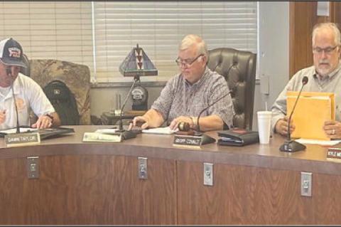 KINGFISHER FIRE Station construction bids were opened Thursday afternoon at Kingfisher City Hall, with Ray Holliday of BRW Architects, Inc., right, announcing the bid amounts from the seven bidding companies and verifying that the proper bidding procedure