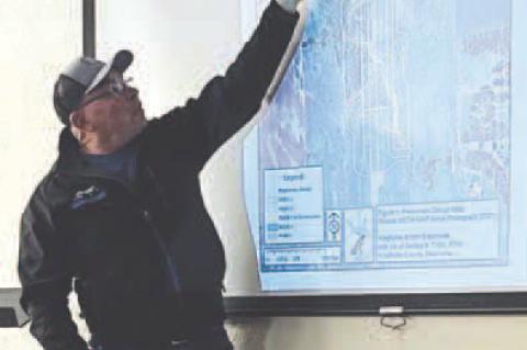 Bill Reitz is pictured going over plans to extend the runway at Kingfisher Municipal Airport. Reitz represented the Kingfisher Airport Authority at a public meeting Thursday at Interbank Community Room. The meeting also featured John Gooden, who represent
