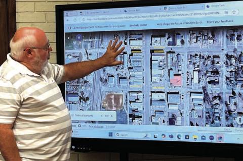 HENNESSEY TOWN Trustee Bert Gritz points out map locations for downtown parking and signage issues during a special meeting of the town board Wednesday, Oct. 23, at Town Hall. [Photo by Barb Walter]