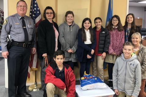 Pictured at the delivery to Kingfisher Police Department are, from left: front row, Alexander Garcia, Noah Hall and Sandy Murray; and back row, KPD Chief Dennis Baker, Sherry Pringnitz, Hannah Borelli, Mia Franco, Karen Munoz, Hailey Crosswhite and Makyla